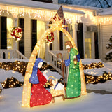Outdoor illuminated holiday decor nativity scene with Mary, Joseph, baby Jesus under an arch, set in snowy yard.