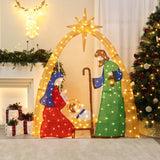 Pre-lit nativity scene holiday decor with Mary, Joseph, baby Jesus under star, set fireplace adorned with garlands, christmas lights, wrapped gifts.