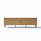 Rectangular wooden TV stand with slender legs, a central circular hole for cables, and a minimalist design.