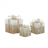 3 square gift boxes with gold ,white glitter, each topped with gold ribbon bow against white background.