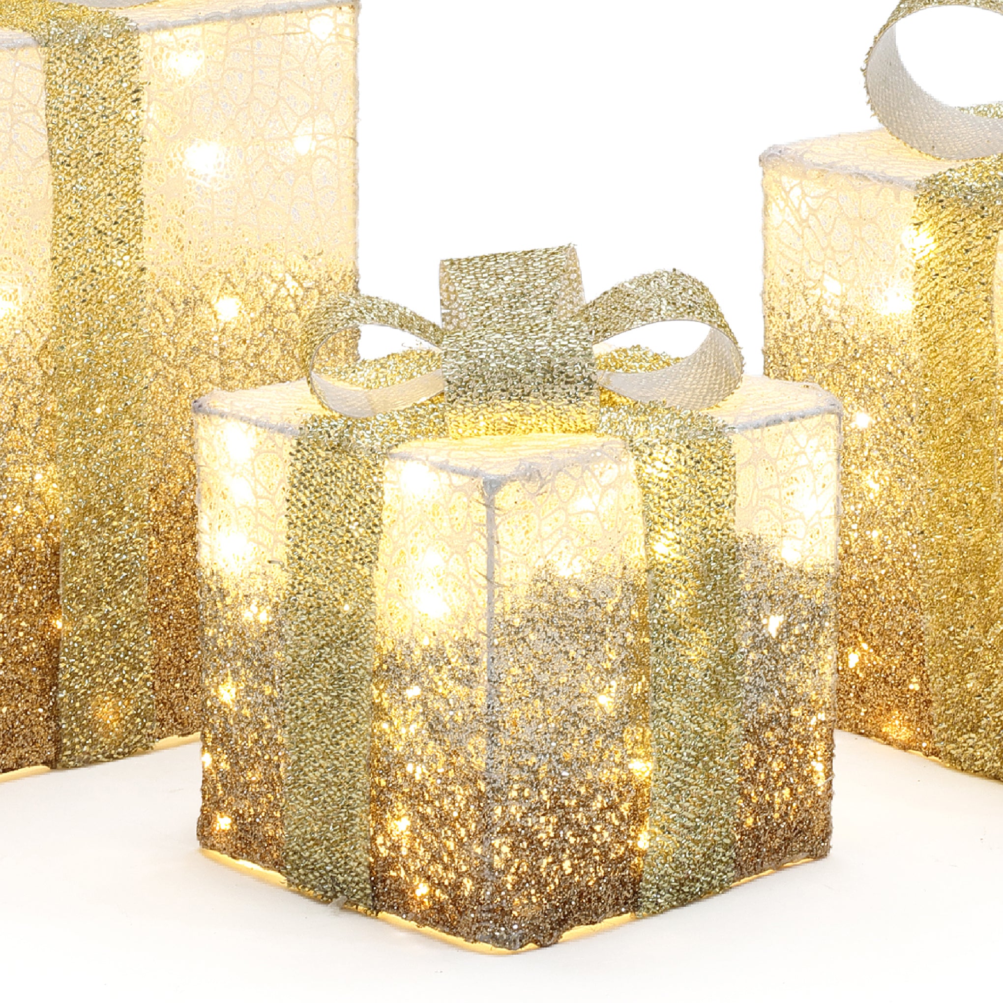 3 decor led gift boxes with gold glitter ,ribbon are illuminated from within, against a crisp white background.