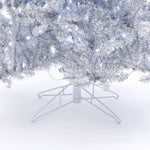 Close-up of the lower branches, metal stand of a 7.5 Foot Silver Artificial Christmas Tree with white string lights..