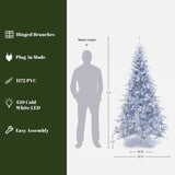 7.5 Ft Christmas Tree with white lights, shown beside a 6 ft person for scale; features hinged branches, plug-in mode, PVC material,  easy assembly.