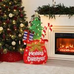 Holiday decor with Lights shaped like santa’s pack , featuring "Merry Christmas", presents, candy canes, sits by decor tree, fireplace.