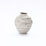 Textured cement vase in light gray with a rounded body and narrow, uneven opening, elevating your home décor.