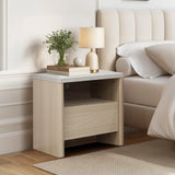 Modern end table with a drawer, open shelf holds a lamp, books, greenery in a vase, and a decorative sphere.