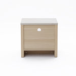 Small square end table featuring a light wood finish and a circular hole, set against a white background.