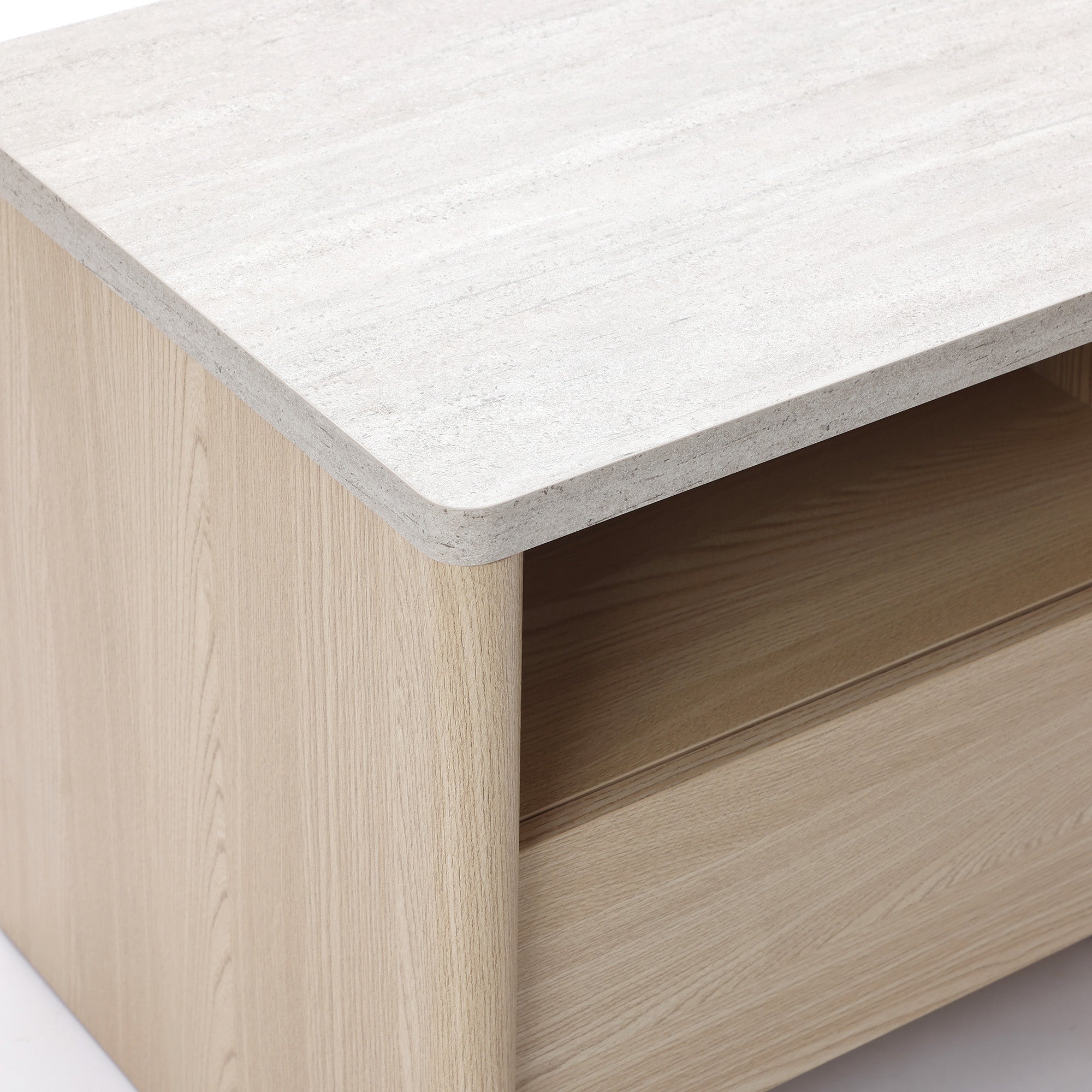Close-up of a modern end table featuring a light-colored, stone-like surface top and a single drawer.