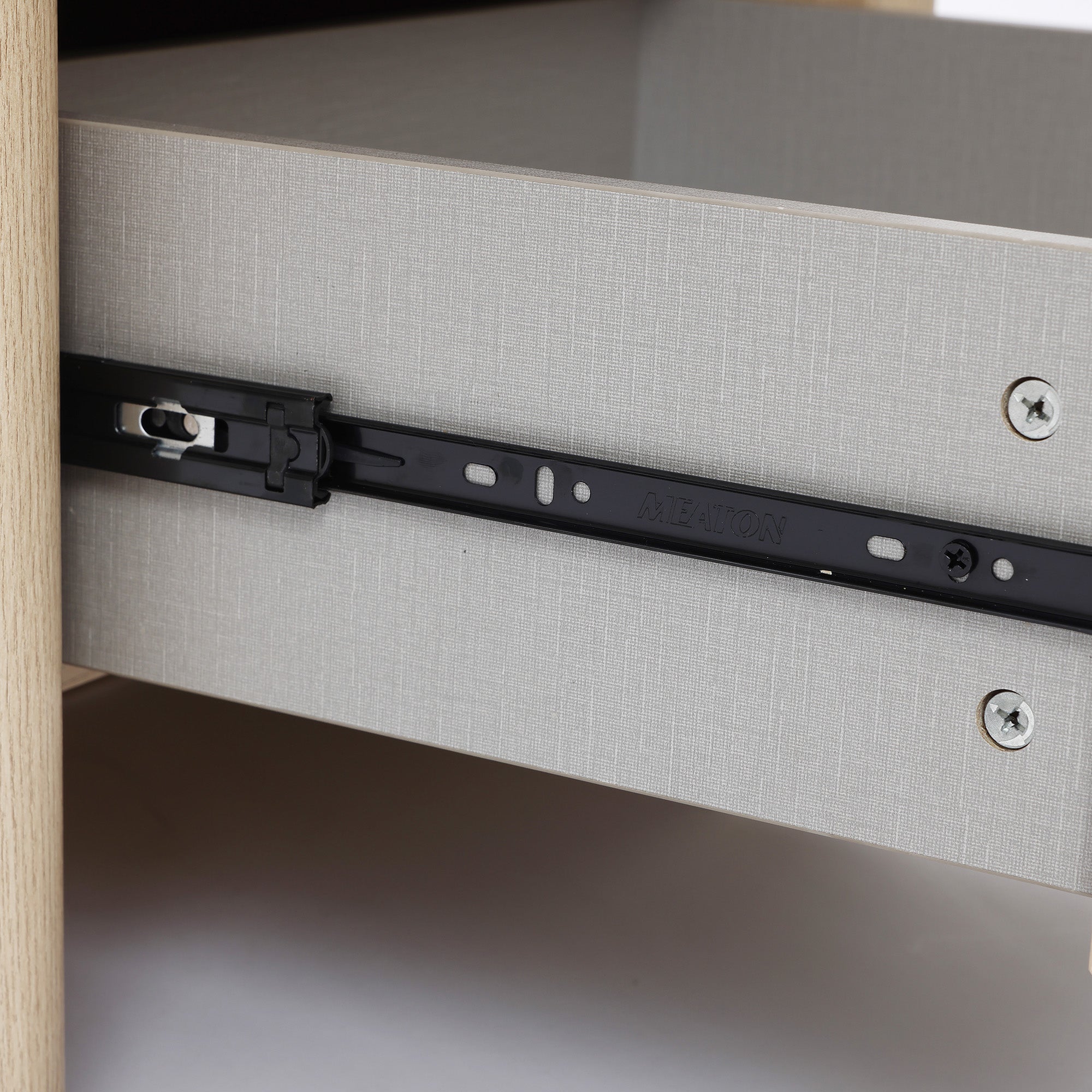 Close-up of a modern end table, showing a black metal sliding rail mechanism attached to the side of the drawer and cabinet.