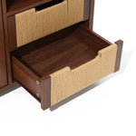 A wood storage cabinet with rope-wrapped handles is partially open, revealing the inside of the drawer and adjacent furniture structure.
