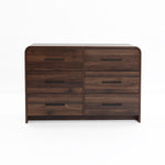 A sleek walnut dresser with six drawers and black handles.