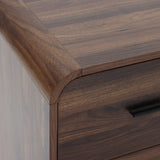 Close-up of the top corner of a walnut nightstand with a smooth finish and a dark metal handle.