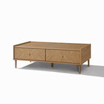 Rectangular Japandi coffee table with two front drawers for storage, four tapered legs, and a natural wood finish.