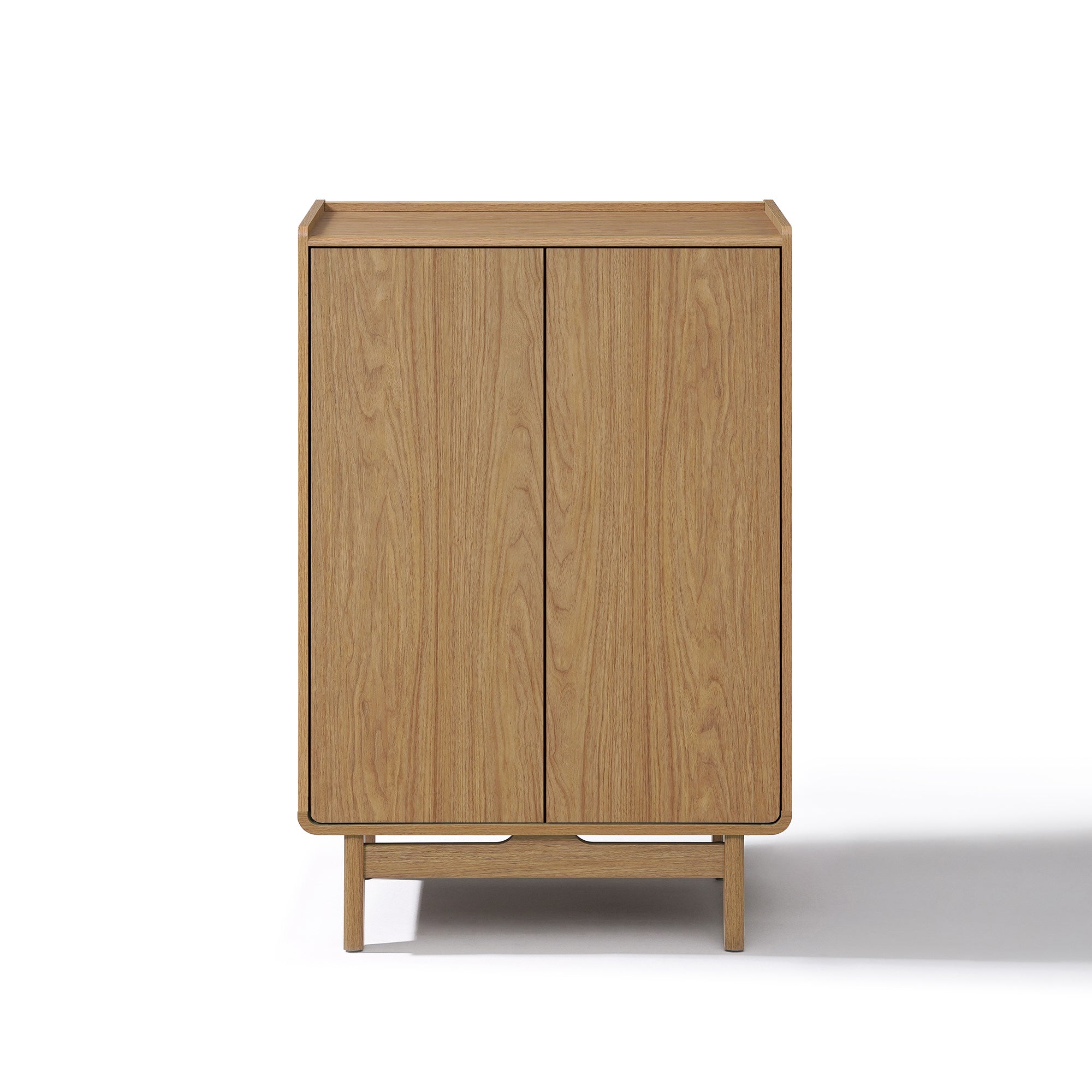 Rectangular light oak wood storage cabinet with two doors and a minimalist design, standing on four short legs.