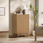 Modern wood storage cabinet with clean lines stands in a bedroom corner, topped with a lamp and small speaker.