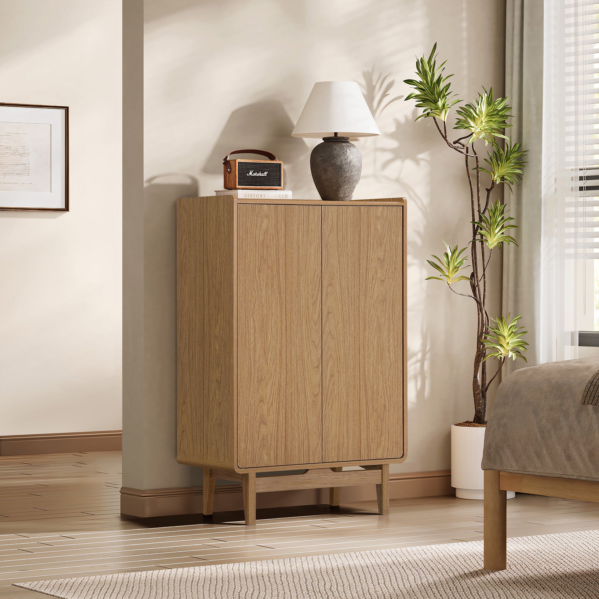 Modern wood storage cabinet with clean lines stands in a bedroom corner, topped with a lamp and small speaker.