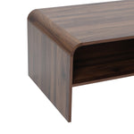 Close-up of the corner of a wooden coffee table with a smooth finish and an open shelf underneath.
