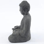 Buddha-statue-sitting-in-meditation-with-his-hands-folded-in-front-of-him-and-his-head-turned-to-the-side