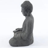 Buddha-statue-sitting-in-meditation-with-his-hands-folded-in-front-of-him-and-his-head-turned-to-the-side