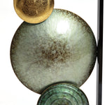 The Glam dishes metal wall art set of 2 from LuxenHome stylishly enhances a modern setting with its textured circular designs: a small gold piece and a large mottled gray one, serving as sophisticated wall decor against a light background.