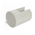 A speckled, ivory white cylindrical object with a slanted top and U-shaped design, resembling a minimalist sculpture, stands elegantly on a white background.