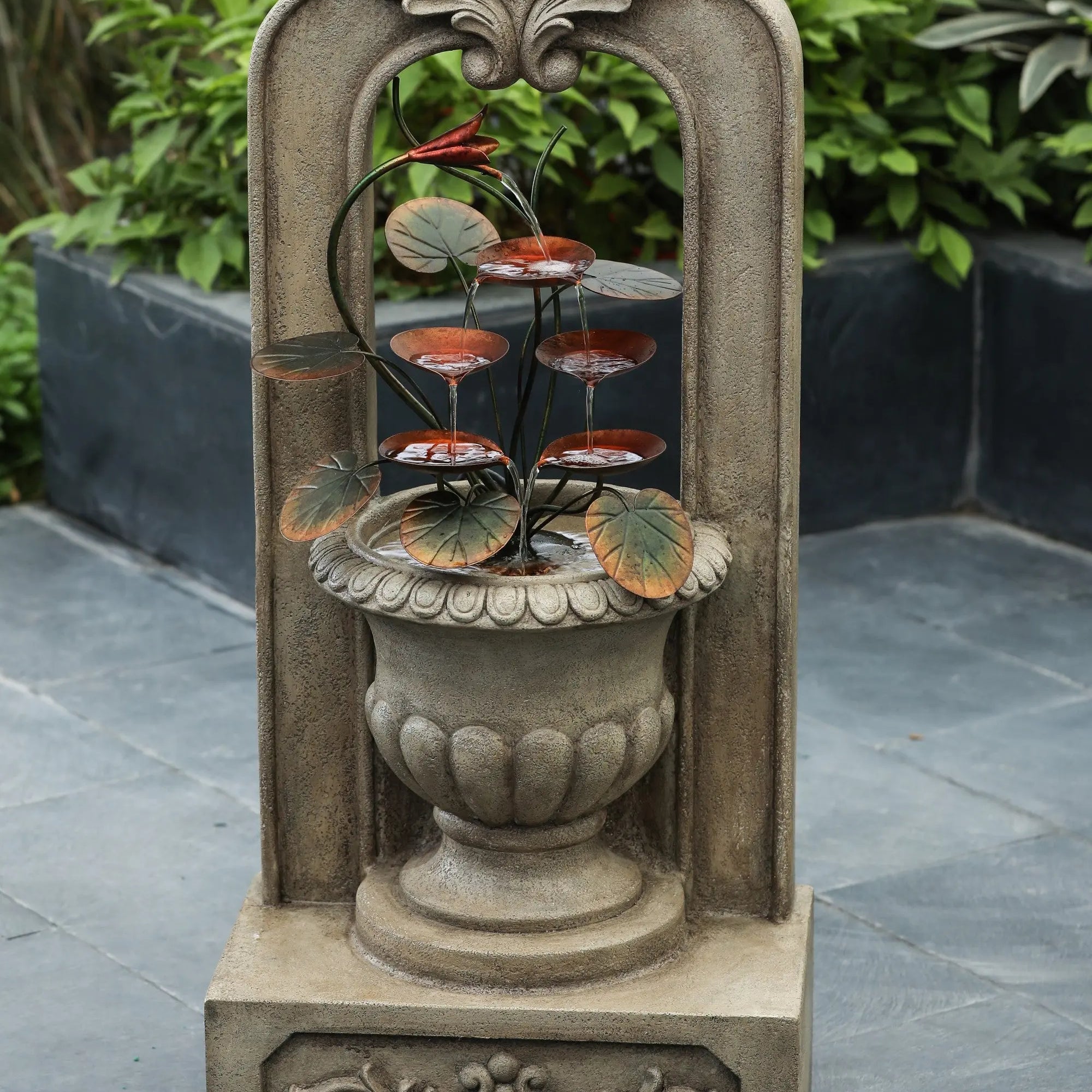 vintage-style-arched-cement-urn-with-metal-flowers-outdoor-fountain