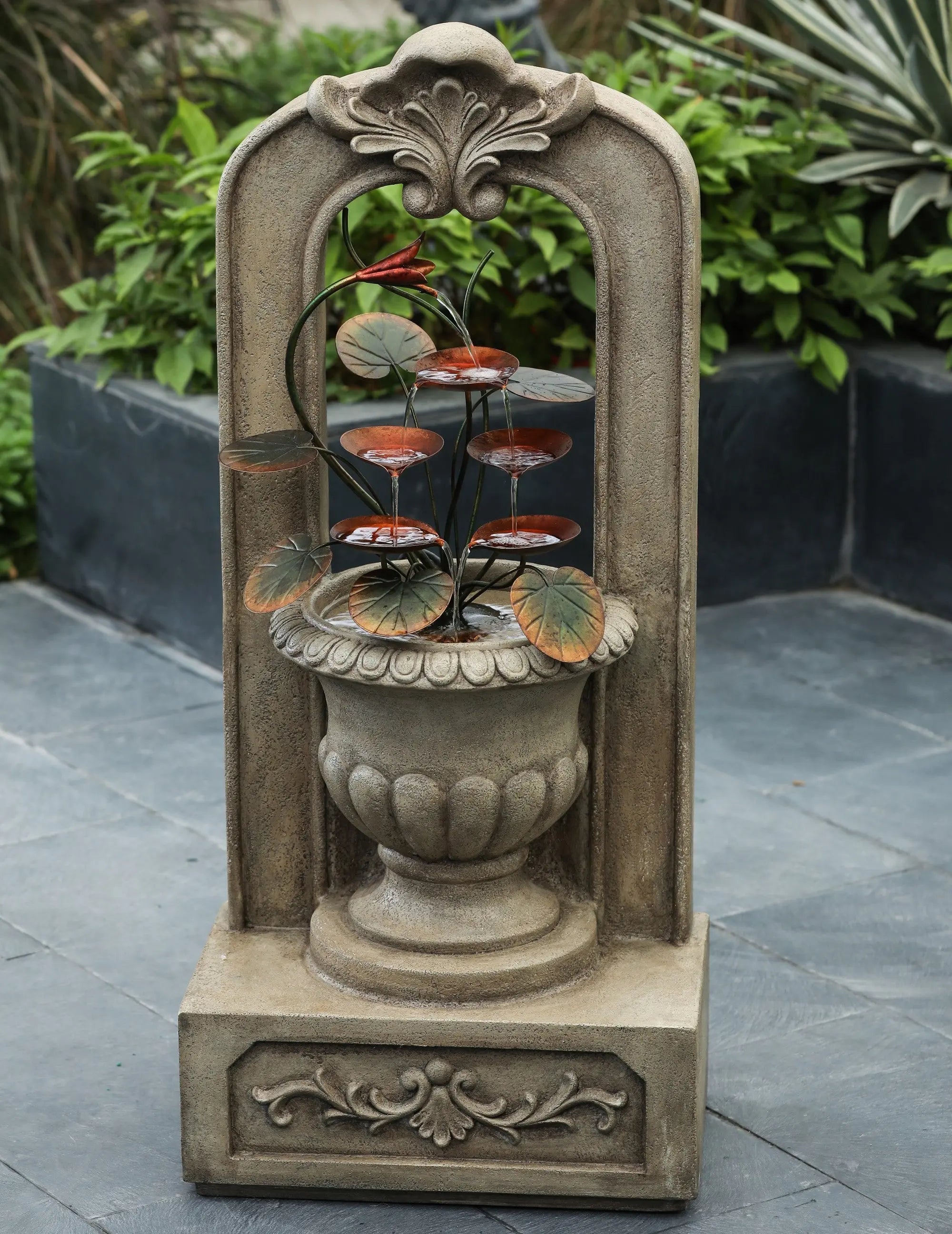 vintage-style-arched-cement-urn-with-metal-flowers-outdoor-fountain