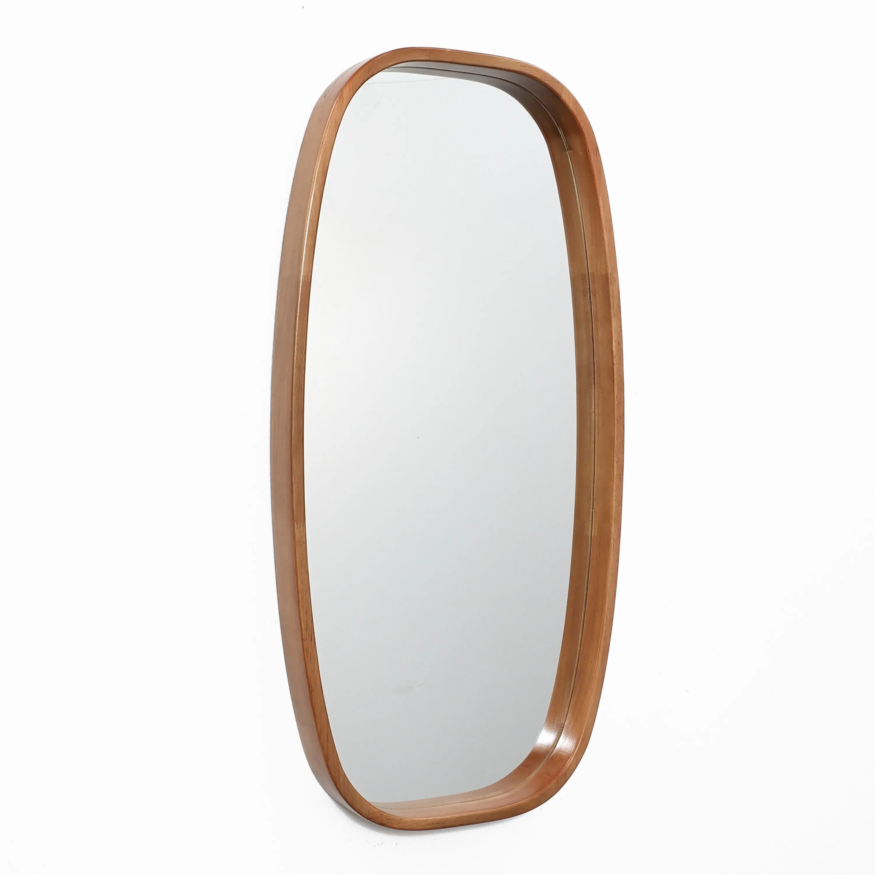 The Jean wood frame rounded rectangle wall mirror by LuxenHome adds a minimalist touch, enhancing the contemporary look of a white wall.