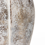 Close-up of a textured surface with speckles of brown and white, reminiscent of a broken egg design, showing a slightly curved line running vertically through the middle.