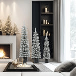 A modern living room with a fireplace, minimalist decor, and several flocked artificial trees of varying heights featuring PVC branches placed near a tall shelf and window.