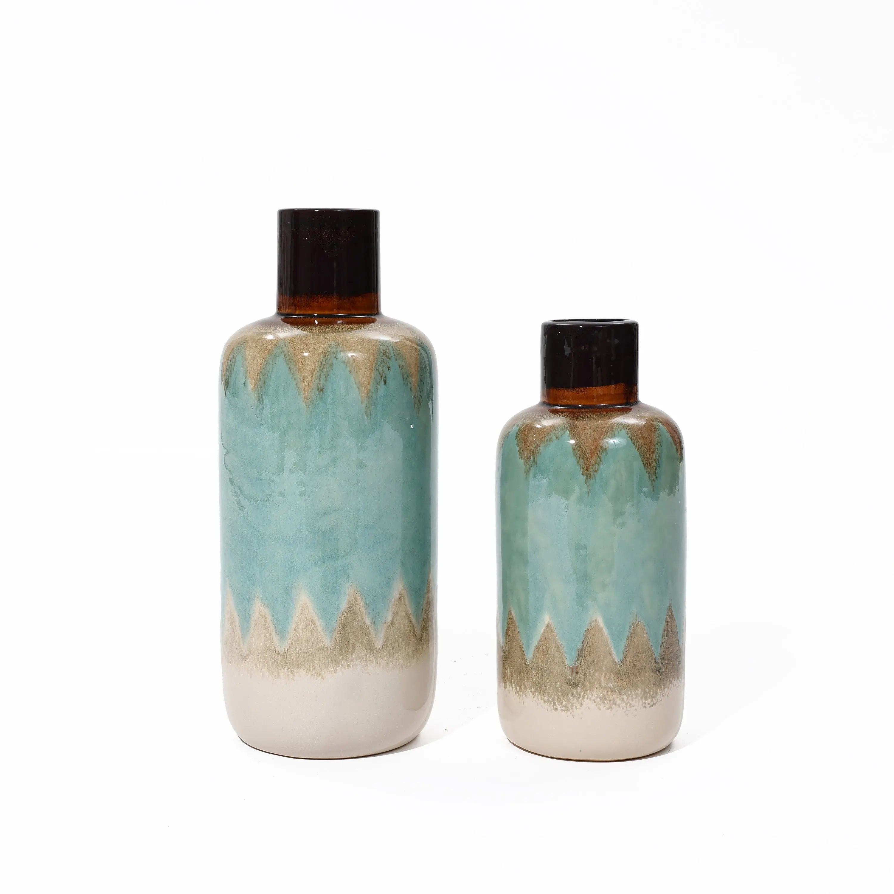 Two tri-color ceramic stoneware vases with dark tops and zigzag turquoise patterns on a white background. One coastal-inspired vase is larger than the other, adding a touch of nautical charm to any space.