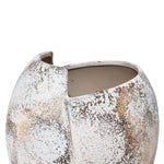 A textured ceramic vase reminiscent of a broken egg design features an irregular, open top and a speckled white and brown surface.
