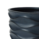Close-up of a dark gray wavy-patterned ceramic pot planter with a smooth texture, perfect for creating a botanical paradise.