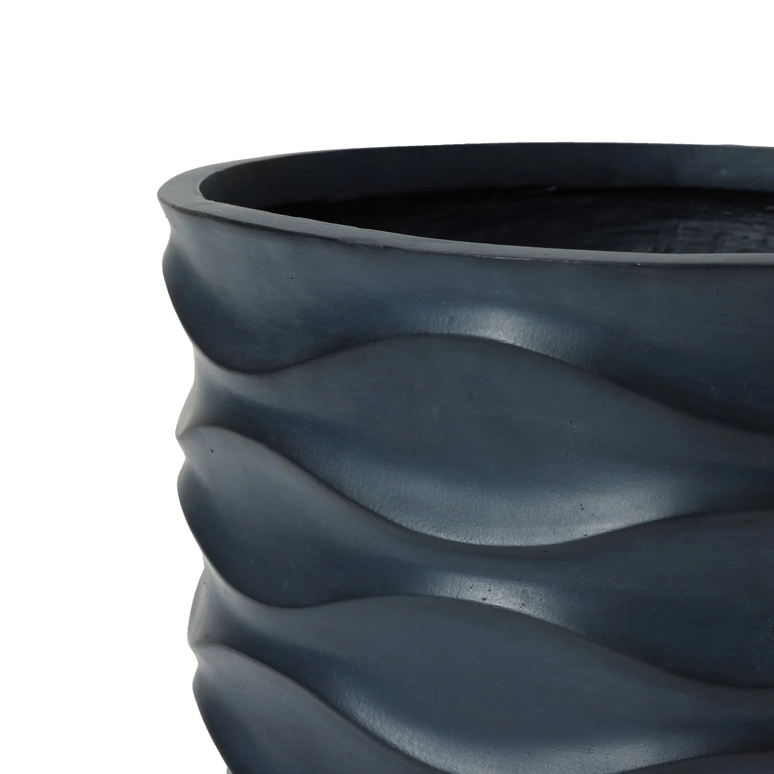 Close-up of a dark gray wavy-patterned ceramic pot planter with a smooth texture, perfect for creating a botanical paradise.