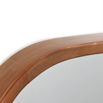 Close-up of a handcrafted rubberwood mirror frame with rounded edges, highlighting the texture and grain of the wood.