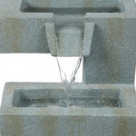 Water flows from an upper rectangular stone basin into a lower basin in this tiered water fountain, perfect for enhancing any outdoor living space against a plain background.