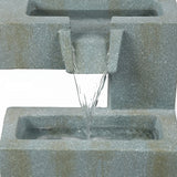 Water flows from an upper rectangular stone basin into a lower basin in this tiered water fountain, perfect for enhancing any outdoor living space against a plain background.