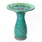 green glazed ceramic bird bath with flower texture