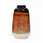 A vintage ceramic vase with a glossy black top transitions elegantly into earthy brown and beige tones, showcasing a color block gradient against a white background, perfect for home decor.