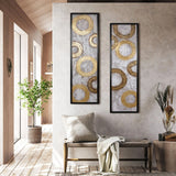 A modern interior features two framed abstract circle paintings enhancing the wall decor, a cozy bench with a pillow and blanket, a potted tree, and a decorative vase with dried plants. Subtle touches of gold metal design add elegance to this harmonious home decor setup.