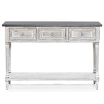 A farmhouse-inspired table featuring a dark top, three front drawers with decorative knobs, carved details, and a lower shelf, all finished in distressed white—perfect as a stylish storage console table for any home.