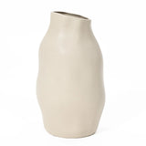 An ivory white ceramic vase with an asymmetrical shape, this accent piece boasts a smooth matte finish, featuring a wavy design and an angled top opening.
