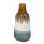 A unique vase with a tall, ribbed ceramic design showcases gradient colors: rich brown at the top, transitioning elegantly to white and finishing with teal at the bottom.