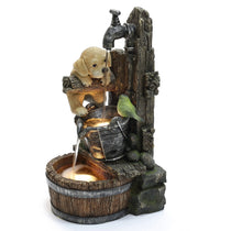 A rustic farmhouse-style fountain featuring a puppy and a bird perched on wooden barrels, with water flowing from a tap into illuminated basins. Its weather-resistant coating ensures durability indoors or outdoors.