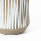 Close-up of a beige and white ceramic vase with vertical ribbed texture, resembling a striped planter, partially visible against a white background.