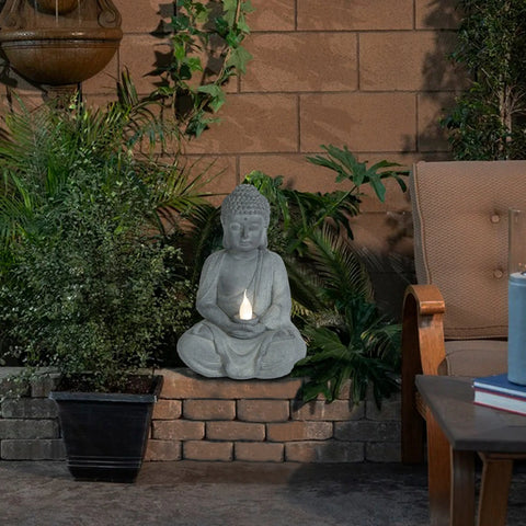 Buddha-statue-and-a-candle-on-a-patio