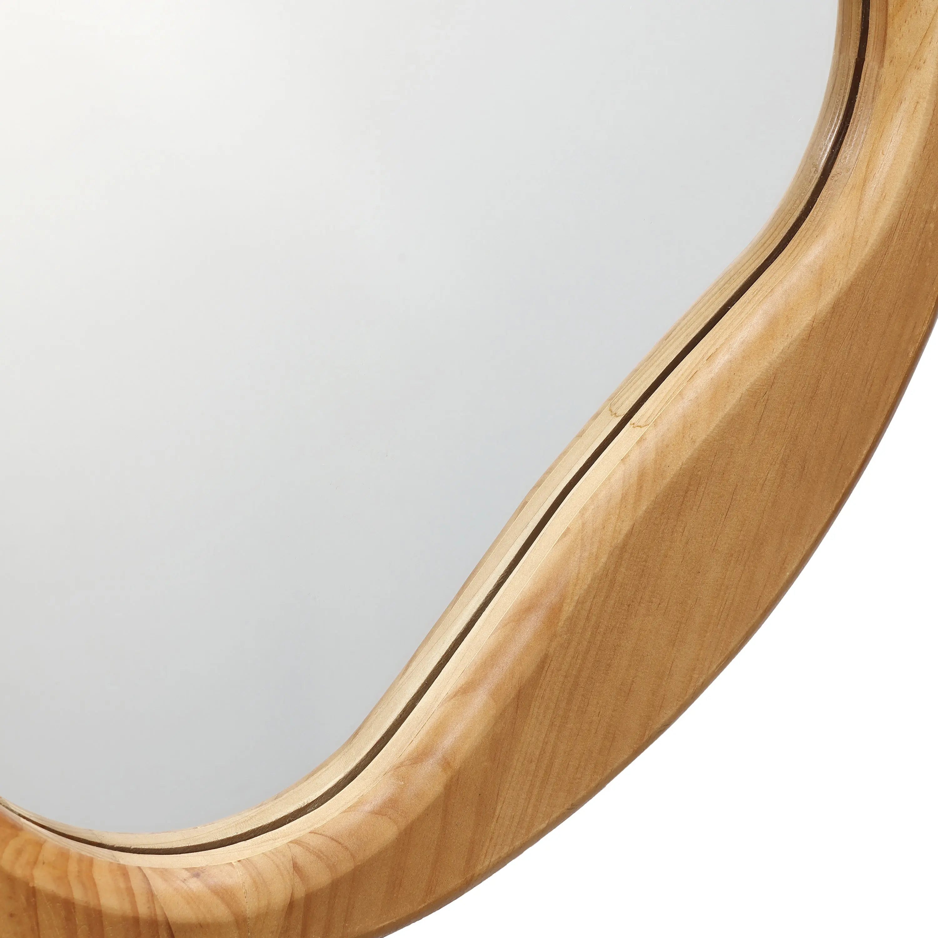Close-up of an oval mirror with a natural wooden frame, displaying smooth curves and a light finish. This versatile accent piece effortlessly complements any space with its elegant design.