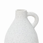 Close-up of a speckled white ceramic vase with a rounded body and a single curved handle on a white background. This vintage vase brings an elegant touch to any home decor, offering timeless charm and style.