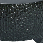 Close-up of a textured, dark green, rounded surface with a pebble-like pattern, reminiscent of a Black Cement Outdoor Coffee Table.