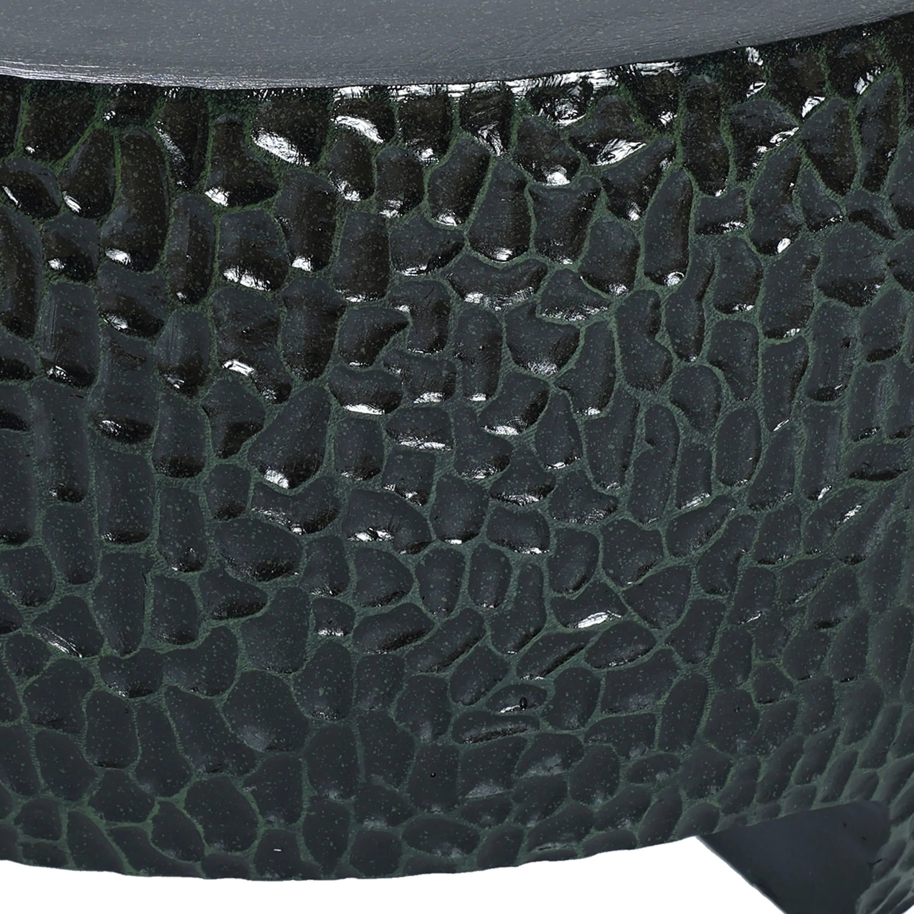 Close-up of a textured, dark green, rounded surface with a pebble-like pattern, reminiscent of a Black Cement Outdoor Coffee Table.